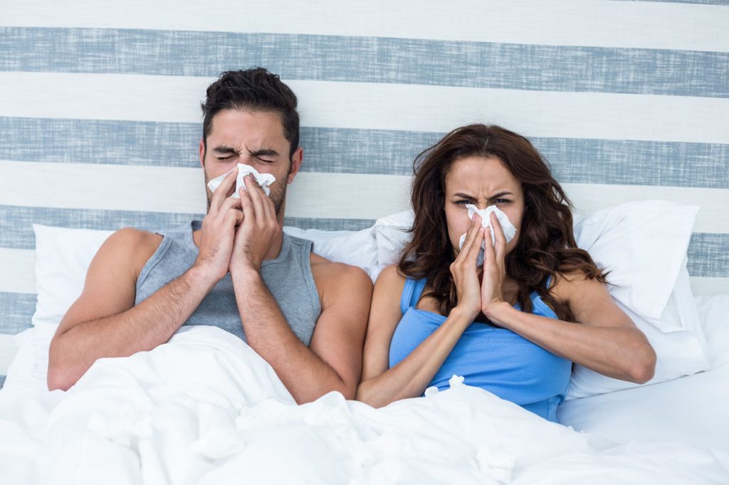 Couple sick on bed